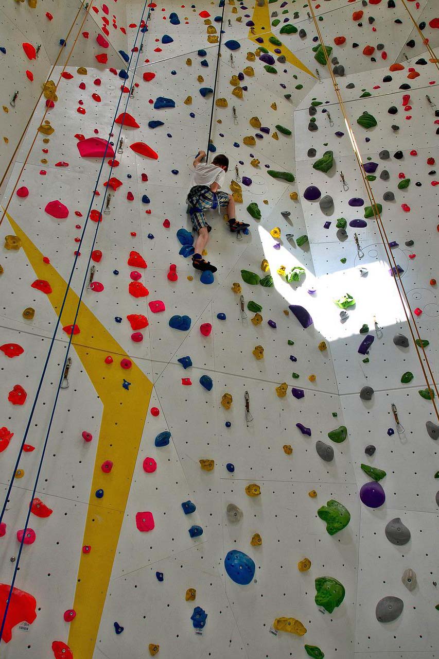 young climber high on wall